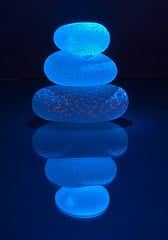 three blue glass pebbles stacked