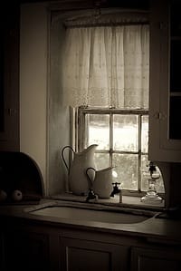 "Farmhouse Sink," curtained window above sink, photo by Corey Leopold 
