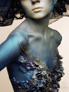 blue girl with feathers and foliage glued on
