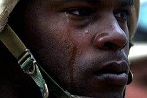 tears or sweat on face of soldier in helmet