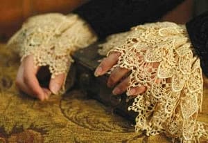 woman's hands in deep lace cuffs