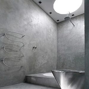 concrete bathroom with stainless facilities and skylight