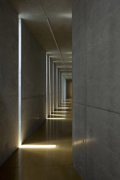 view down narrow marble hallway