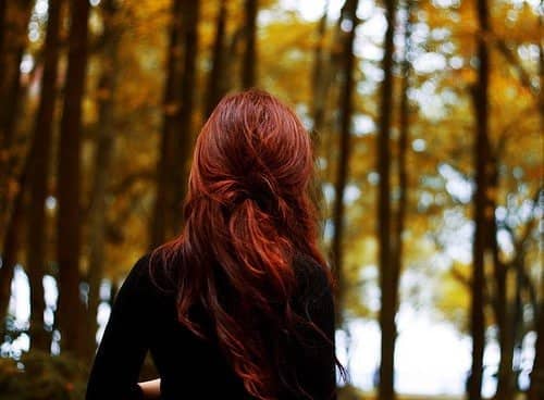 red-haired woman in windy woods